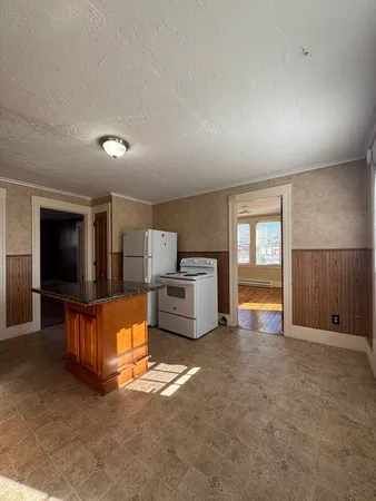 a kitchen with granite countertop a sink and a stove