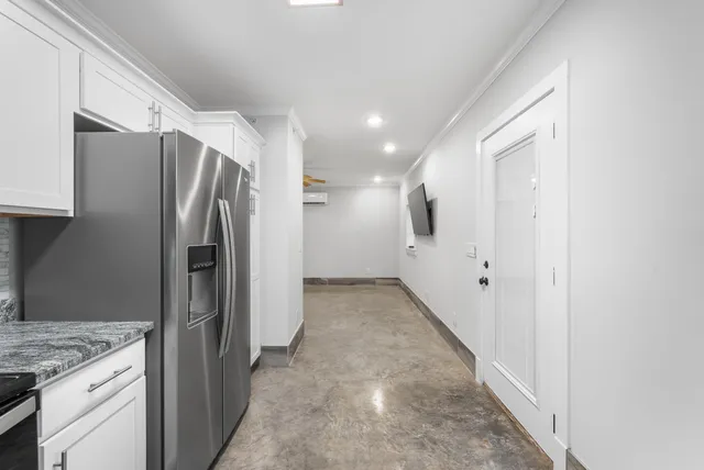 a view of a kitchen with a refrigerator and a sink