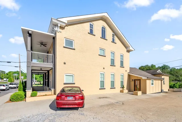 a front view of a house with a garden