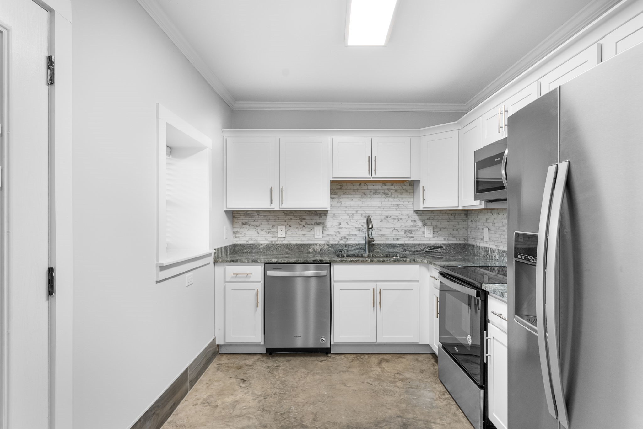 638 Madison Street, Unit 6 Clarksville, TN 37040 - Photo 6 of 25 a kitchen with stainless steel appliances granite countertop a stove a refrigerator and a sink