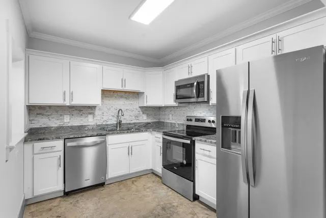 a kitchen with stainless steel appliances granite countertop a refrigerator stove a sink and dishwasher
