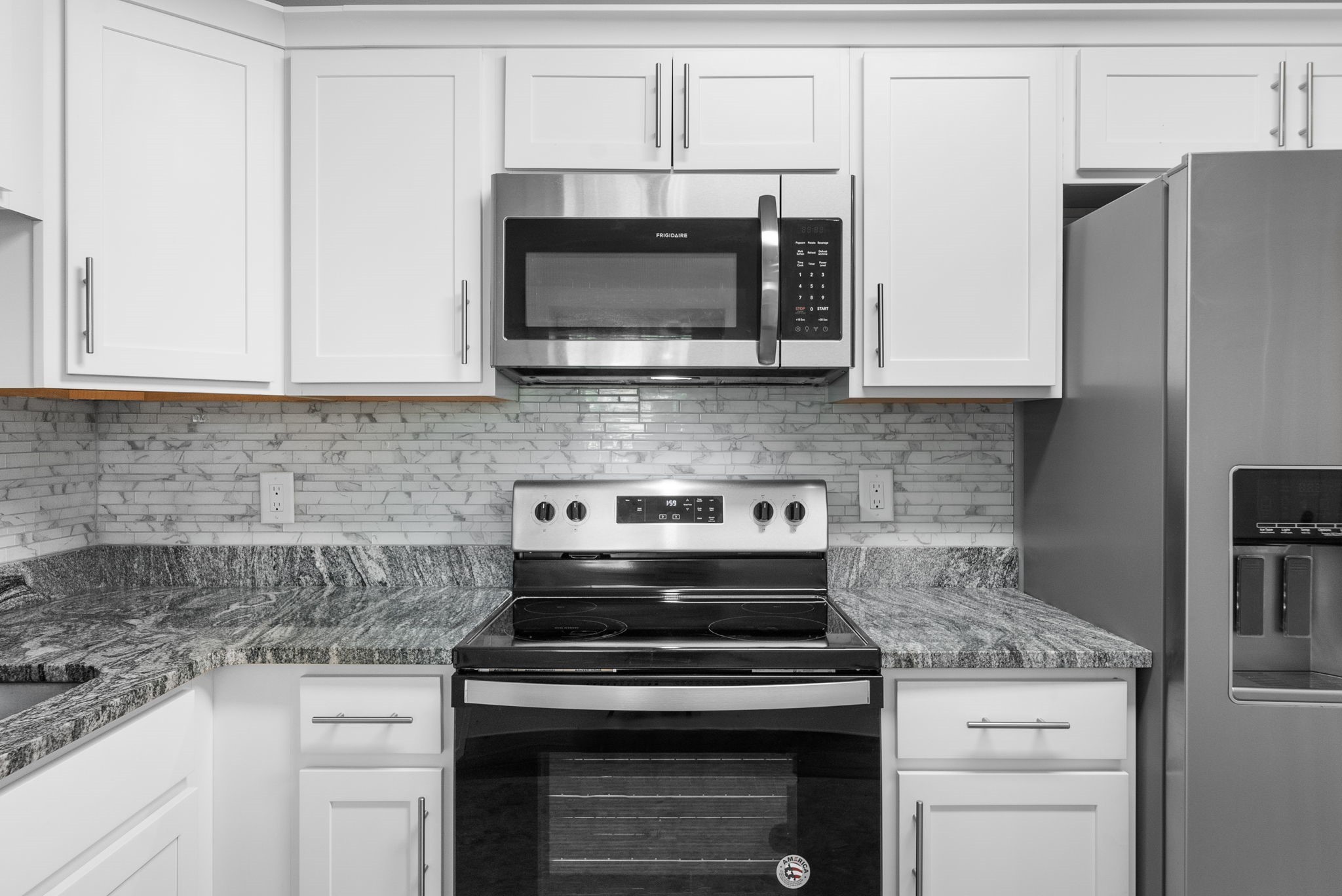 638 Madison Street, Unit 6 Clarksville, TN 37040 - Photo 10 of 25 a kitchen with stainless steel appliances granite countertop white cabinets and a stove a oven with white countertops