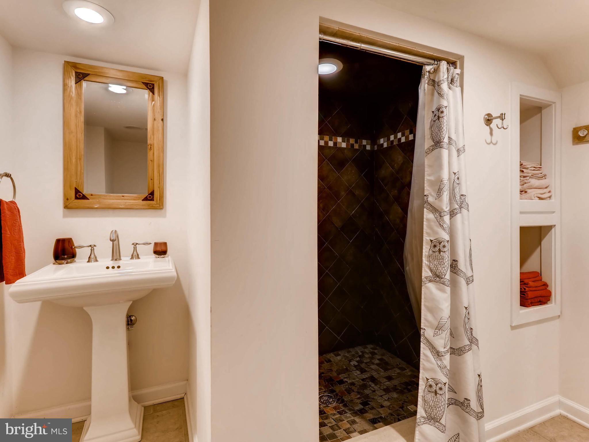 604 Coleraine Road Catonsville, MD 21229 - Photo 26 of 30 a bathroom with a sink and a mirror