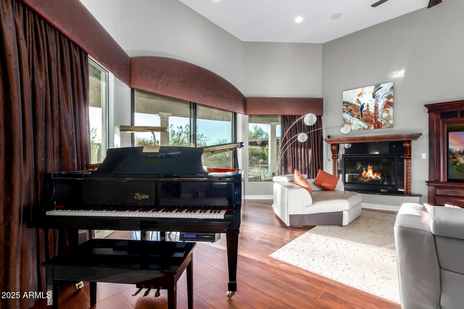 27314 North Azatlan Drive Rio Verde, AZ 85263 - Photo 13 of 62 a living room with furniture a fireplace and a large window