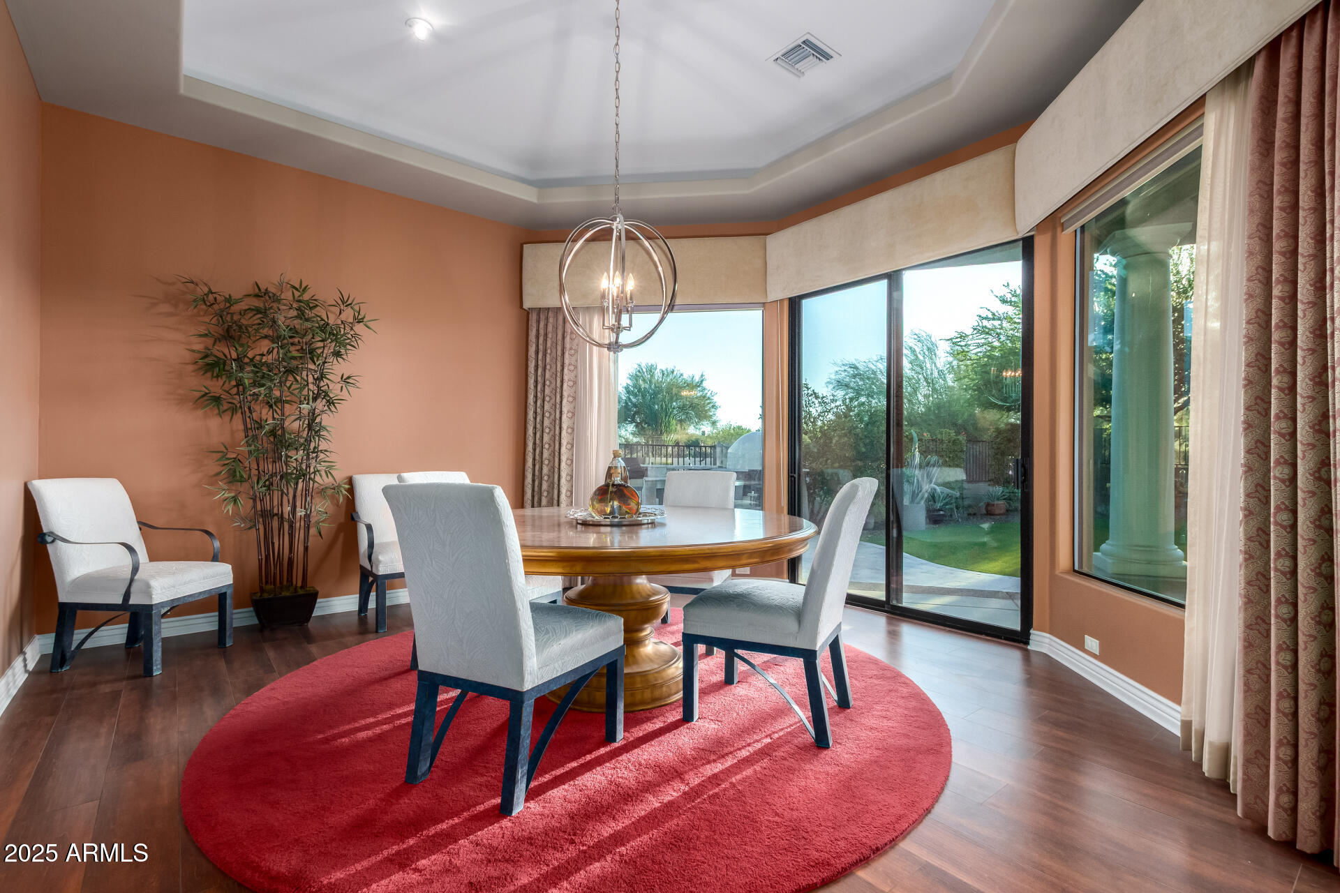 27314 North Azatlan Drive Rio Verde, AZ 85263 - Photo 15 of 62 a dining room with furniture a chandelier and wooden floor