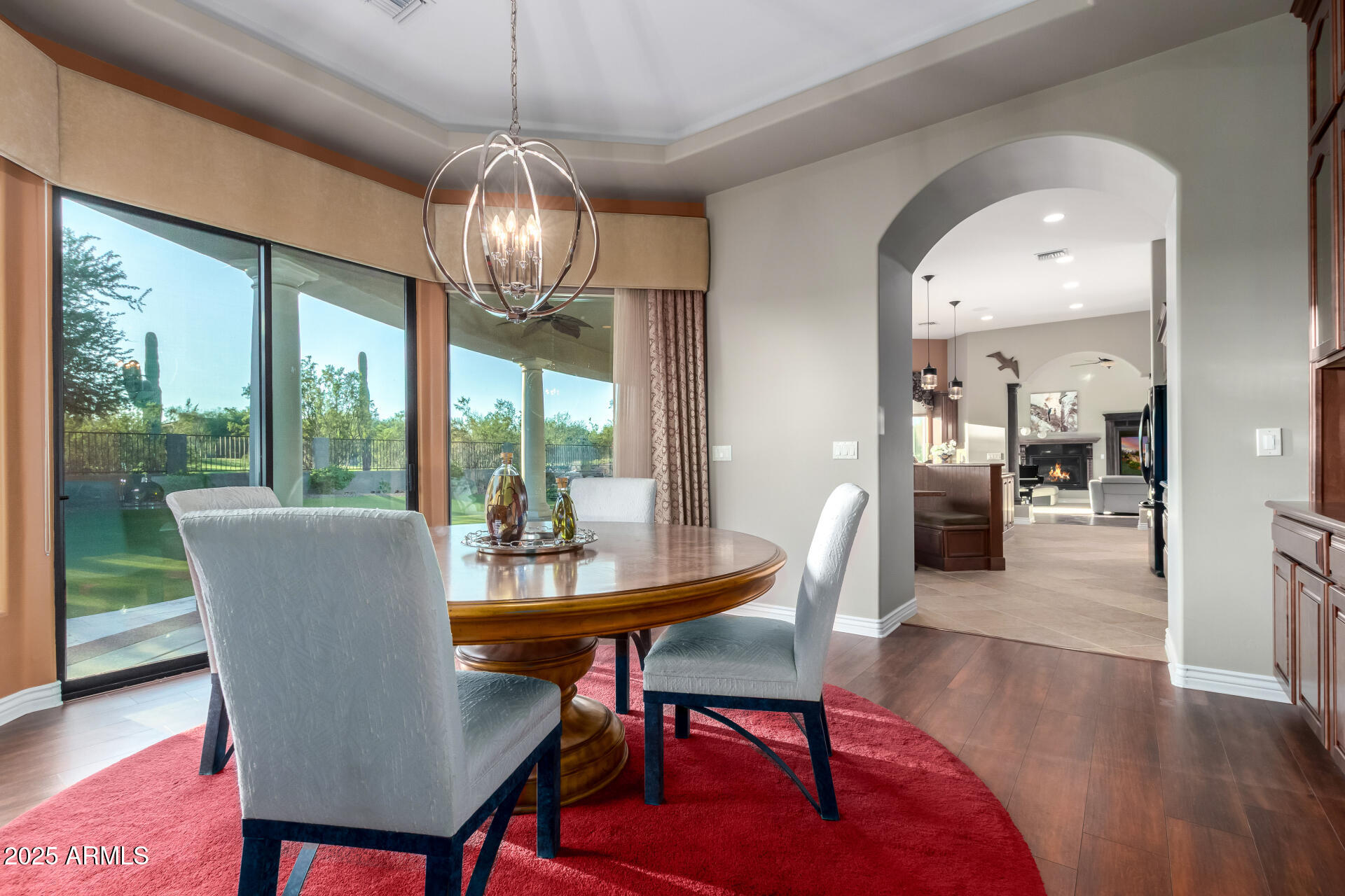 27314 North Azatlan Drive Rio Verde, AZ 85263 - Photo 16 of 62 a dining room with furniture a chandelier and wooden floor