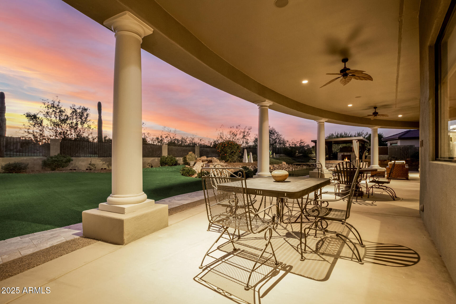 27314 North Azatlan Drive Rio Verde, AZ 85263 - Photo 37 of 62 a view of a patio with a dining table and chairs