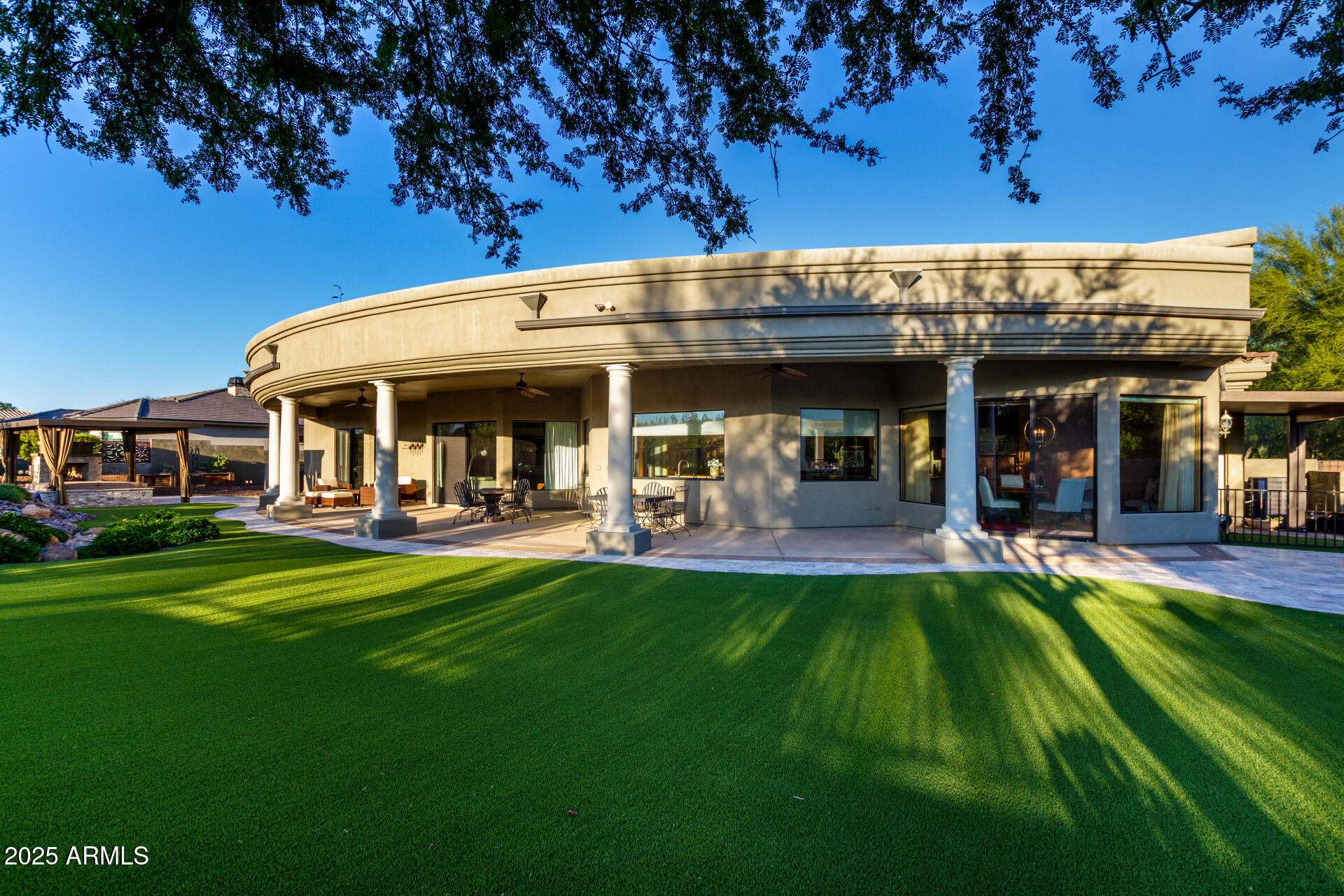 27314 North Azatlan Drive Rio Verde, AZ 85263 - Photo 43 of 62 a view of a swimming pool with a table and chairs under an umbrella