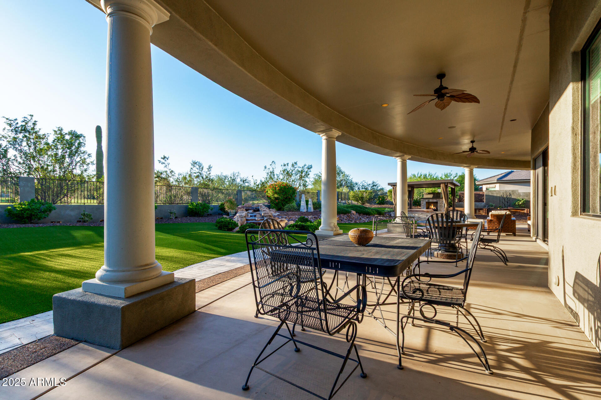 27314 North Azatlan Drive Rio Verde, AZ 85263 - Photo 46 of 62 a view of a patio with a table chairs and a backyard