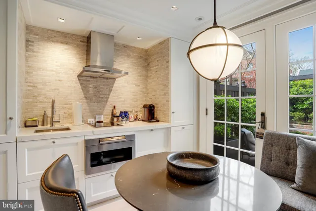 a living room with a fireplace and a large window