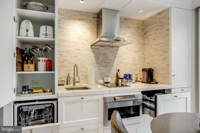 a kitchen with a sink cabinets and appliances