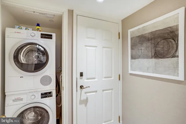 a view of a hallway with washer and dryer