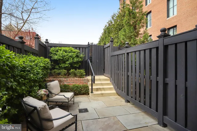 a view of backyard with seating space and trees
