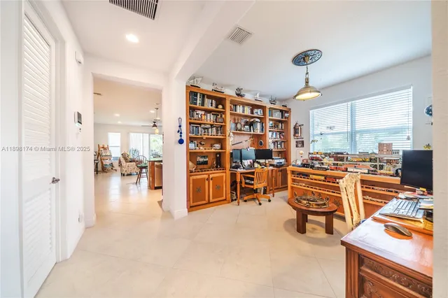 a view of a livingroom with workspace and a window