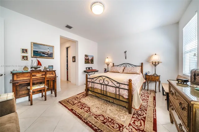 a bedroom with a bed and a desk