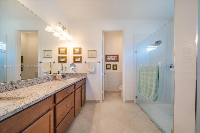 a spacious bathroom with a granite countertop sink mirror and a