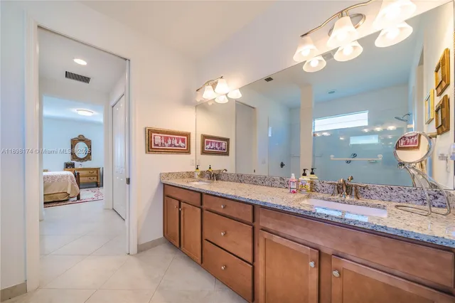 a bathroom with a sink double vanity and a mirror