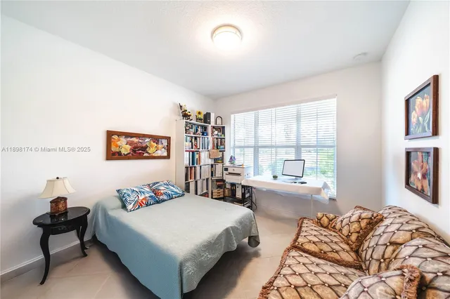 a bedroom with furniture and a window