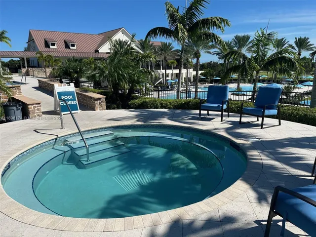 a swimming pool with outdoor seating yard and barbeque oven