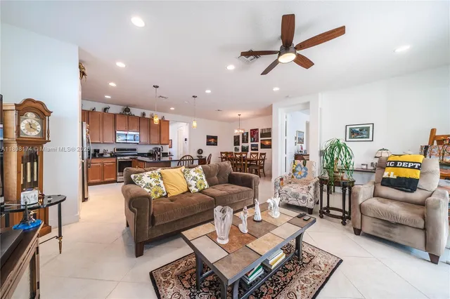 a living room with furniture and kitchen view