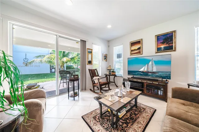 a living room with furniture a rug and a large window