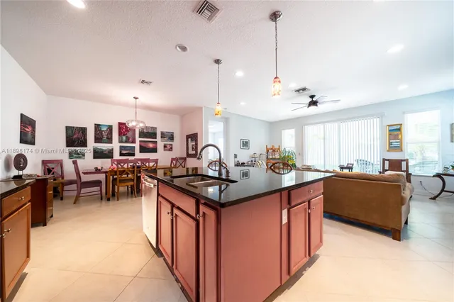 a kitchen with stainless steel appliances granite countertop stove top oven and cabinets