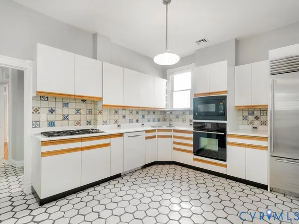 a kitchen with stainless steel appliances a stove and a refrigerator