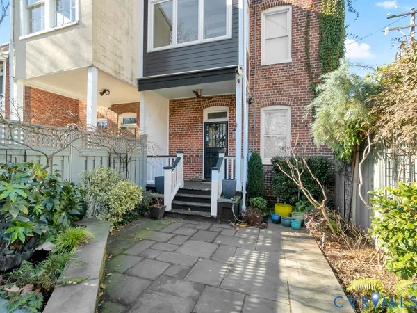 a view of a room that has a window and wooden floor