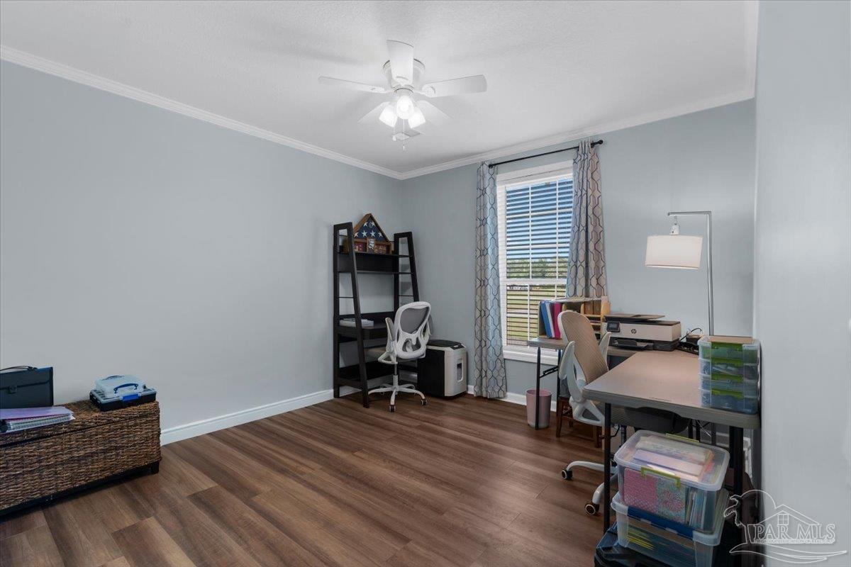 4955 Blue Ribbon Drive Milton, FL 32583 - Photo 19 of 32 a bedroom with furniture and a wooden floor