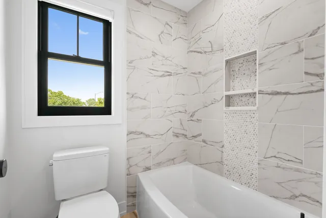 a bathroom with a toilet and a bathtub