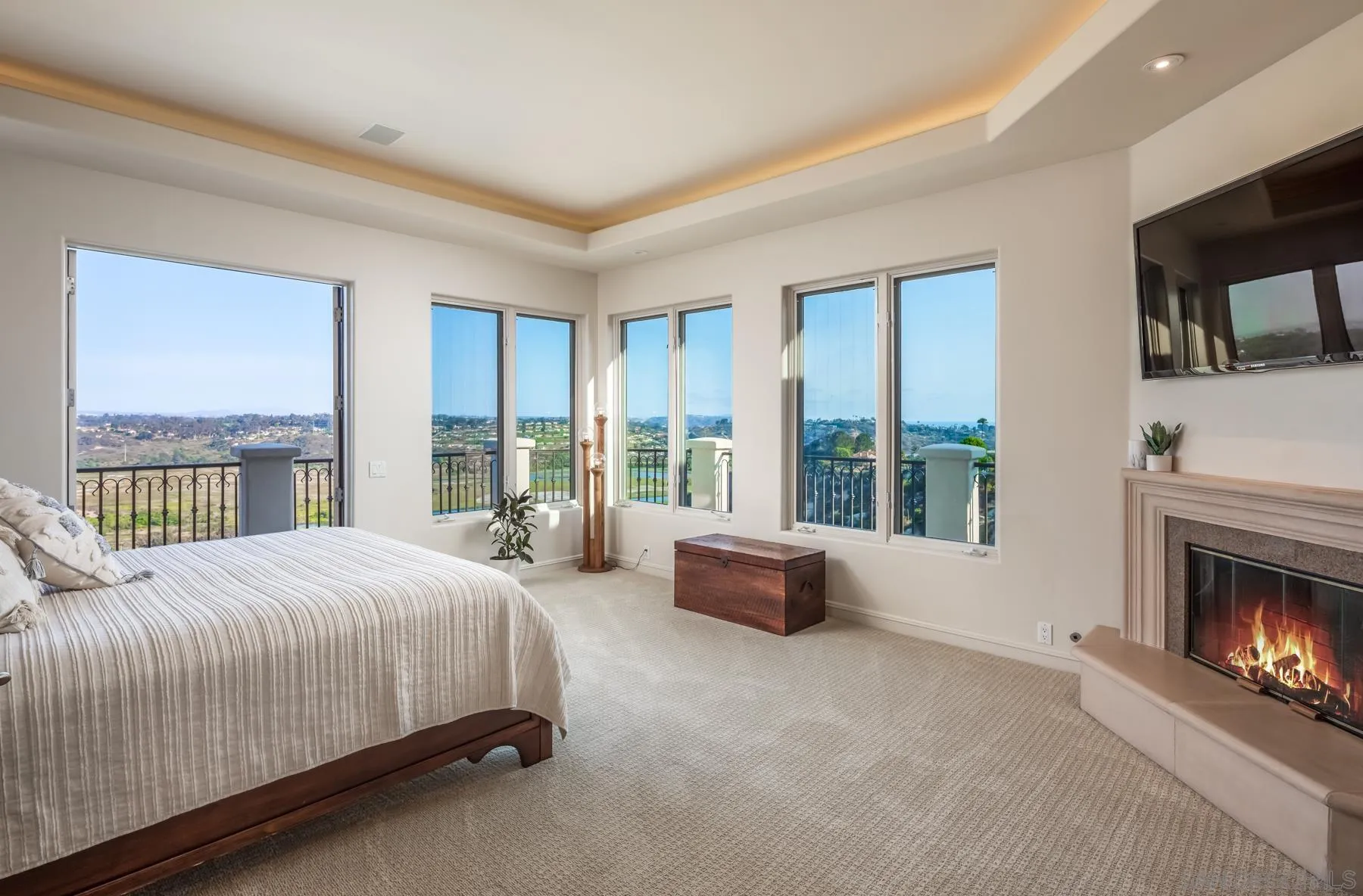1375 Este Vista Court Encinitas, CA 92024 - Photo 14 of 31 a spacious bedroom with a large bed and a fireplace