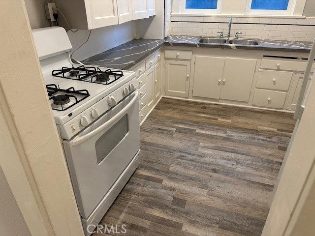 1025 Locust Avenue Long Beach, CA 90813 - Photo 15 of 64 a kitchen with granite countertop white cabinets and white appliances