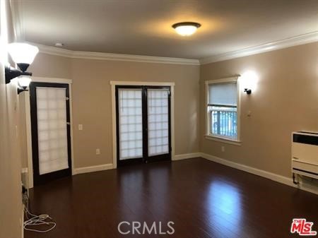 1025 Locust Avenue Long Beach, CA 90813 - Photo 24 of 64 a view of an empty room with wooden floor and a window