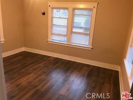 1025 Locust Avenue Long Beach, CA 90813 - Photo 28 of 64 a view of an empty room with wooden floor and a window