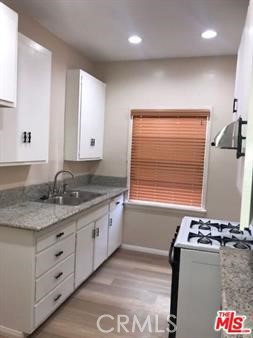 1025 Locust Avenue Long Beach, CA 90813 - Photo 30 of 64 a kitchen with stainless steel appliances granite countertop a stove and a sink