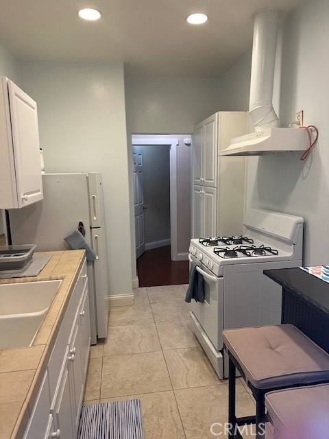 1025 Locust Avenue Long Beach, CA 90813 - Photo 33 of 64 a kitchen with stainless steel appliances granite countertop a sink stove and refrigerator