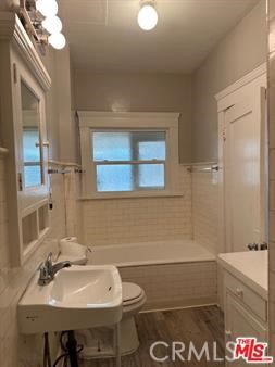 1025 Locust Avenue Long Beach, CA 90813 - Photo 45 of 64 a bathroom with a sink a toilet and shower