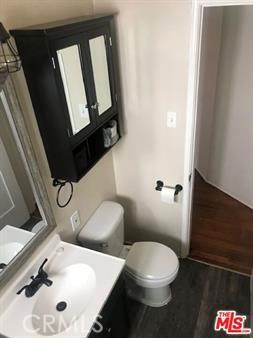 1025 Locust Avenue Long Beach, CA 90813 - Photo 48 of 64 a bathroom with a toilet sink and mirror