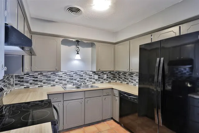 a bathroom with a granite countertop sink a toilet and shower
