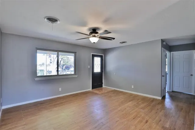 wooden floor in an empty room with a window