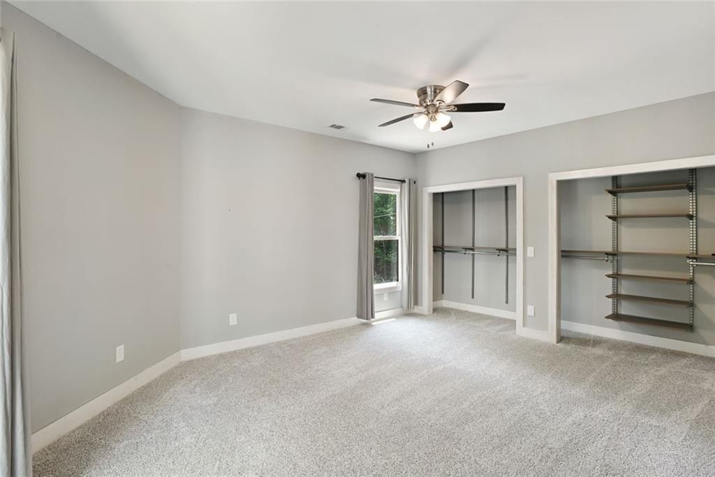 2040 Ridge Road Cumming, GA 30041 - Photo 29 of 52 a view of an empty room with a ceiling fan