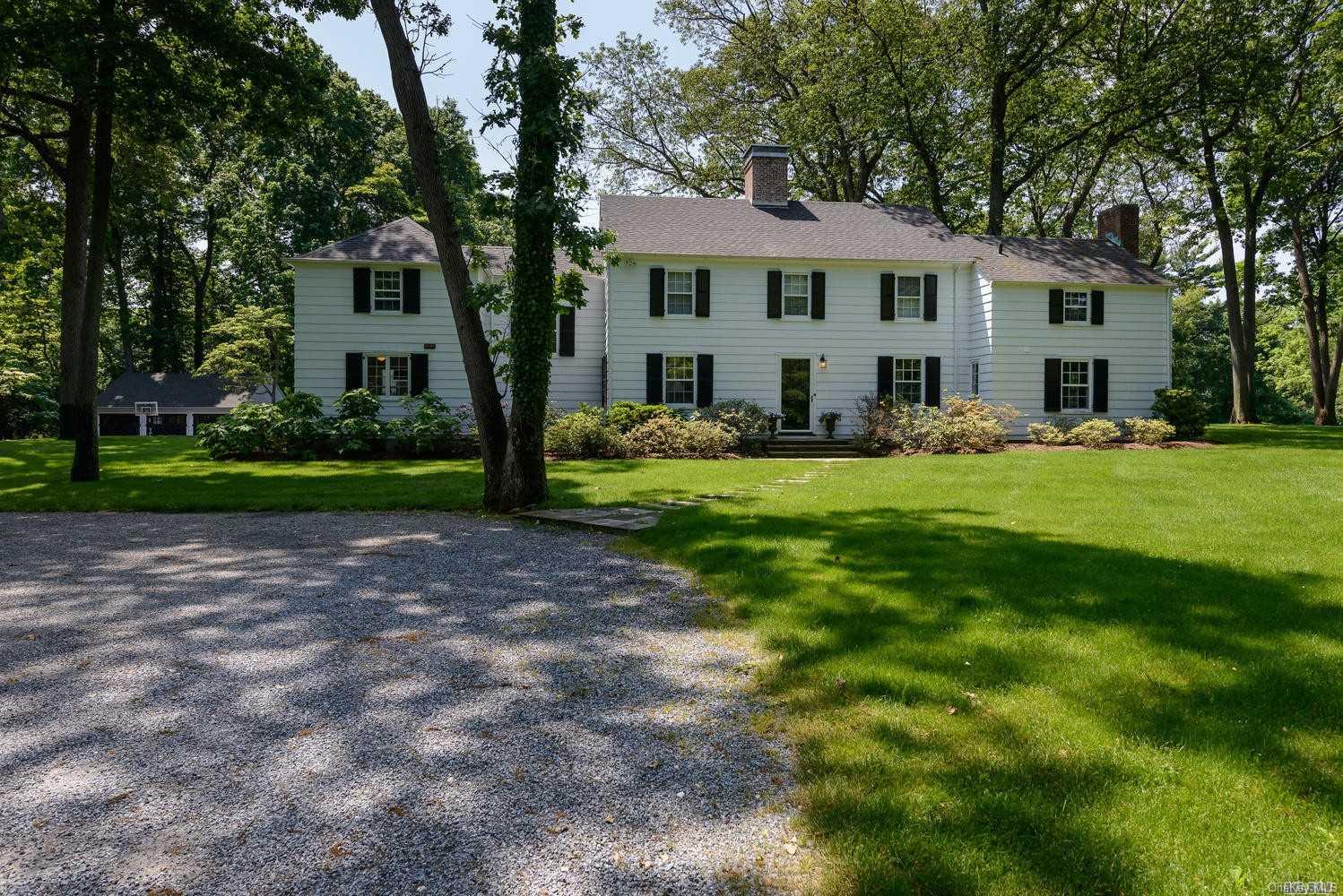 64 Snake Hill Road Cold Spring Harbor, NY 11724 - Photo 1 of 1 a front view of a house with a yard