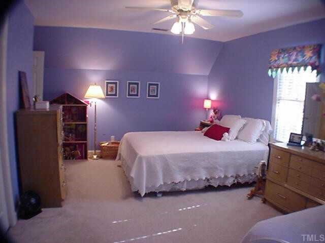 8804 Wellsley Way Raleigh, NC 27613 - Photo 7 of 10 a bedroom with a bed and a chandelier