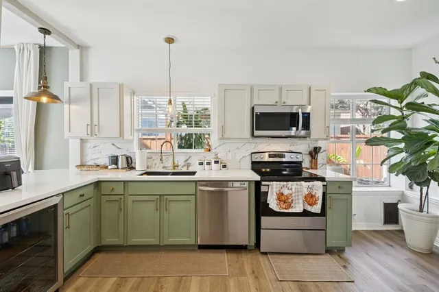 a kitchen with a stove sink and microwave