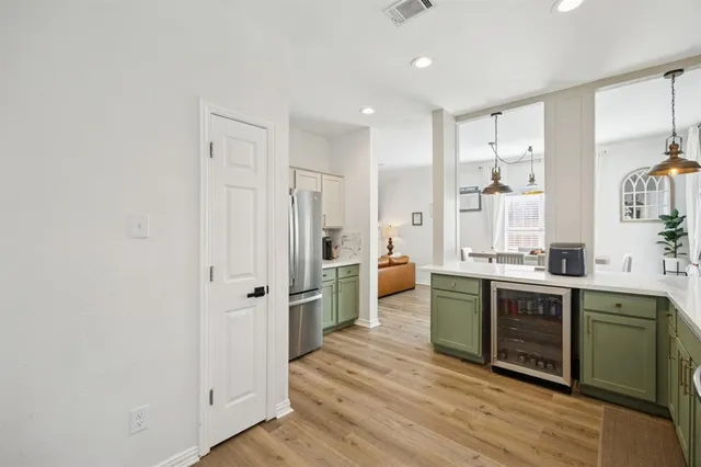 a large kitchen with a lot of counter space and wooden floor