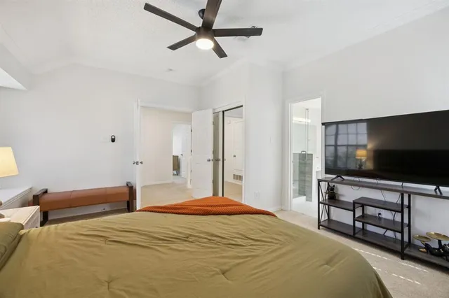 a bedroom with bed and a flat screen tv