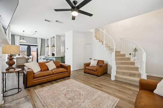 a living room with furniture and wooden floor