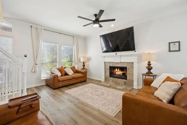 a living room with furniture fireplace and flat screen tv