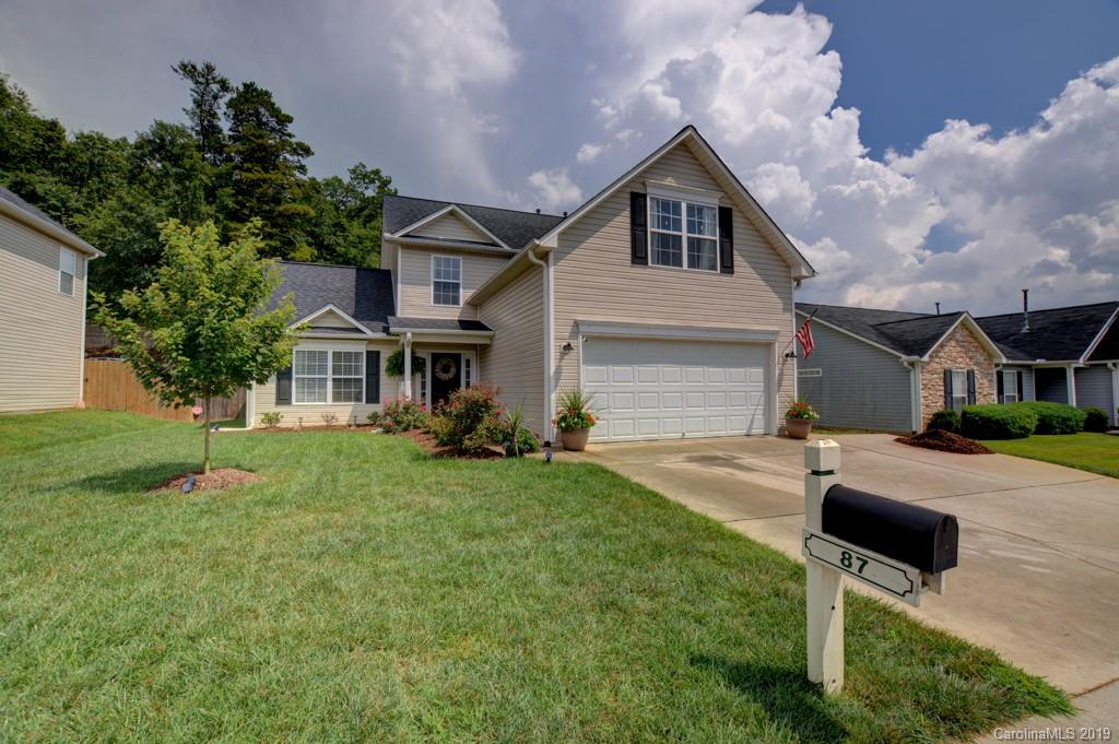87 Yadkin Road Fletcher, NC 28732 - Photo 1 of 34 a front view of a house with a yard and trees