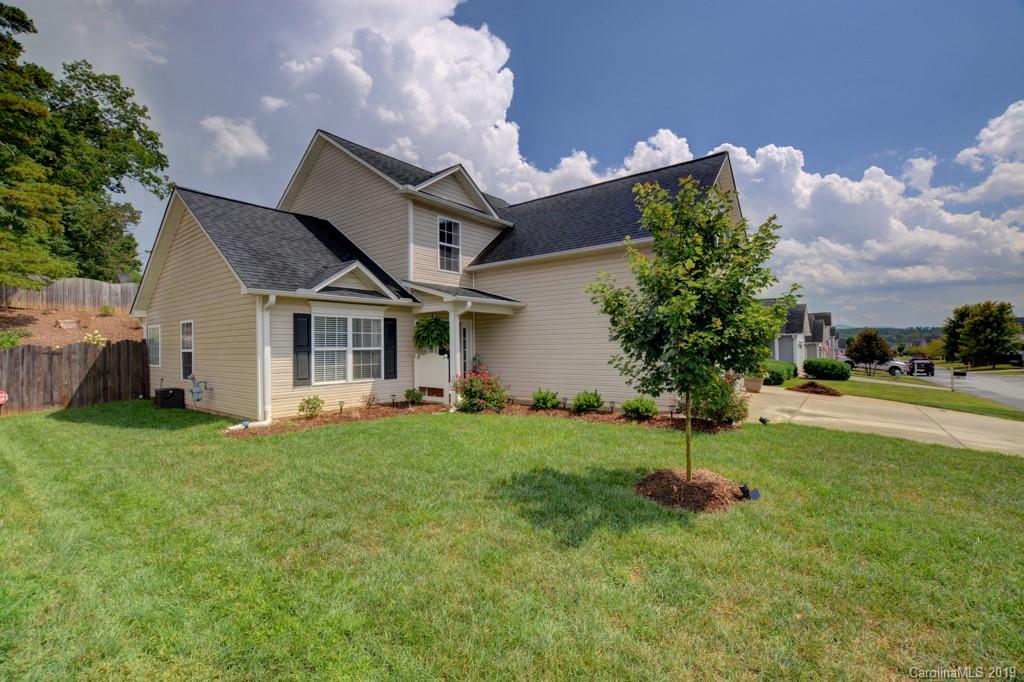 87 Yadkin Road Fletcher, NC 28732 - Photo 2 of 34 a front view of a house with a yard and garage
